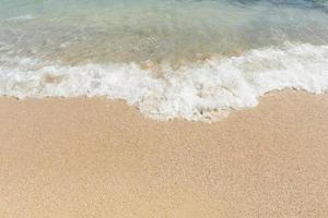 Soft wave of sea on empty sandy beach Background with copy space photo