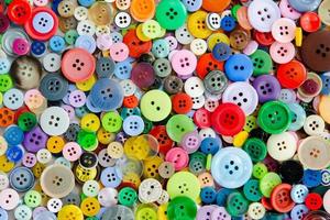 Colorful mixed sewing buttons background. Top view photo