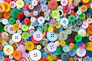 Colorful mixed sewing buttons background. Top view photo
