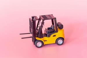 Logistics, and delivery service - Forklift model on Pink background. Shopping service on The online web and offers home delivery. photo