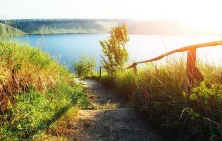 Fantastic views of the trail on the hill leading to the picturesque lake. photo