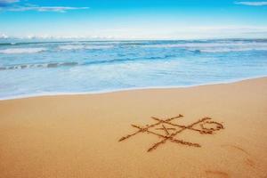 Figures in the sand on the beach photo