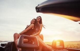 Young two women at a photo shoot. Girls gladly posing