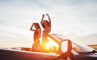 Young two women at a photo shoot. Girls gladly posing