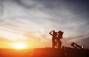 Young two women at a photo shoot. Girls gladly posing