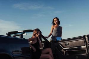 Beautiful two girls are photographed on the road photo