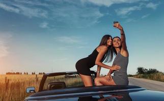 Beautiful two girls are photographed on the road photo