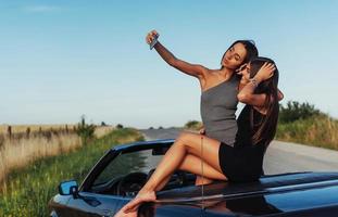 Beautiful two girls are photographed on the road photo