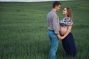 Happy couple awaiting baby. Beautiful and young parents photo