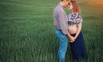 Happy couple awaiting baby. Beautiful and young parents photo