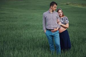 Happy couple awaiting baby. Beautiful and young parents photo