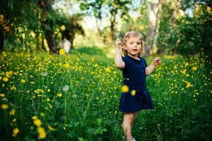 child playing outdoors in the grass photo