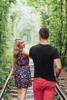 Loving couple in love tunnel iron road