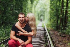 Loving couple in love tunnel iron road photo