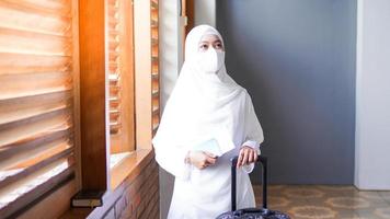 asian women muslim wearing mask in mosque photo