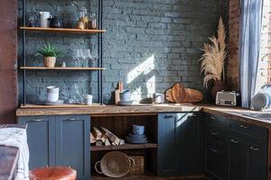 Scandinavian classic minimalistic dark gray kitchen with wooden details. Stylish loft modern gray kitchen decoration with clean contemporary style interior design. photo