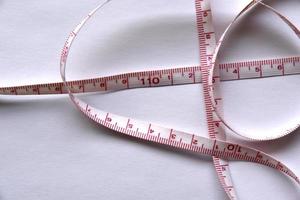 Sewing centimeter centimeter tape tailor's meter measuring tape on a white background photo
