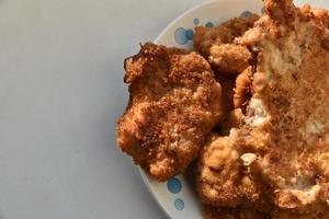 Pieces of fried pork meat on a plate photo