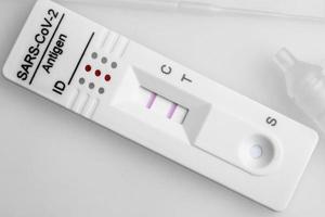 Positive test result by using rapid test device for COVID-19. photo