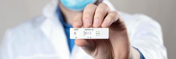 Positive test result by using rapid test device for COVID-19. photo