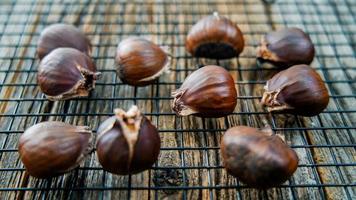 Chestnuts on cooling screen on rustic table
