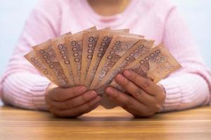 Close up of asian woman with calculator counting money.Woman calculate the spending at home. photo