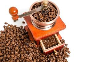 Retro wooden coffee grinder on white background with coffee beans.