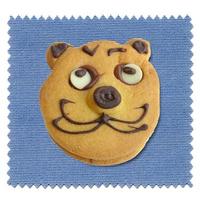 Baked cookie with cat face over blue tablecloth photo