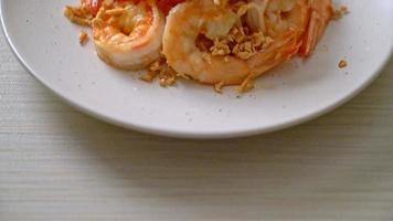 fried shrimps or prawns with garlic on white plate - seafood style video