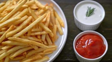 French fries or potato chips with sour cream and ketchup