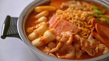 Budae Jjigae or Budaejjigae or Army stew or Army base stew. It is loaded with Kimchi, spam, sausages, ramen noodles and much more - popular Korean hot pot food style