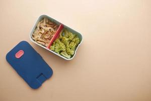 top view of a lunch box on color background photo