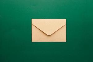 a envelope drops on a green color background photo