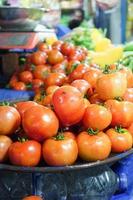 fresh tomato with water drop display for sale at local store photo