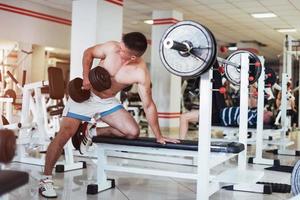 Portrait of a beautiful athletic guy muscles with weights photo