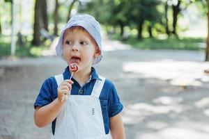 young boy with colorful lollipop photo