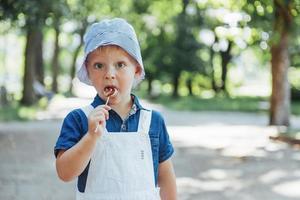 young boy with colorful lollipop photo