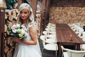 Portrait of gorgeous bride with a wedding bouquet photo