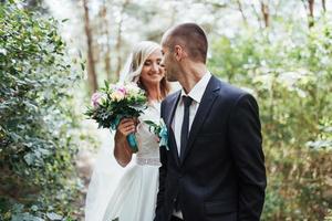 Happy young couple poses for photographers on her happiest day. photo