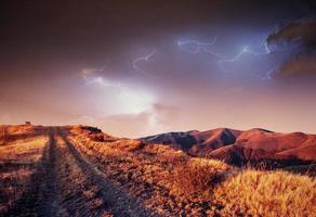 Fantastic collage. Beautiful lightning over the snow-capped moun photo