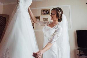 girl trying on wedding dress