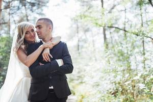 groom at a park on their wedding day photo