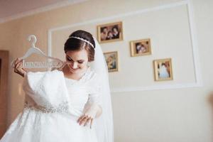 girl trying on wedding dress photo