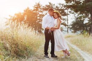 Happy young couple in a pine forest in summer photo