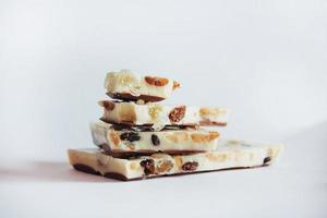 white chocolate with nuts, raisins on a background photo