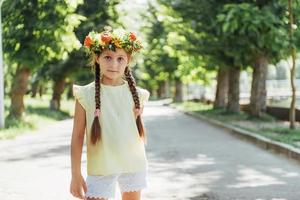 Happy Baby summer. Beautiful girl with a wreath of flowers photo
