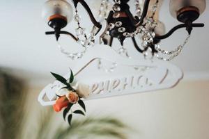 white clothes hanger on a light for wedding dress photo