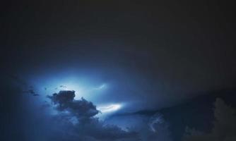 Lightning strike on the cloudy dark sky. Fantastic summer night photo