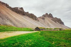 Traditional Viking village. Wooden houses near the mountain firs photo