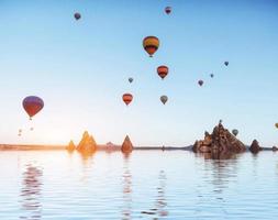 Composition of balloons over water and valleys, gorges, hills, b photo